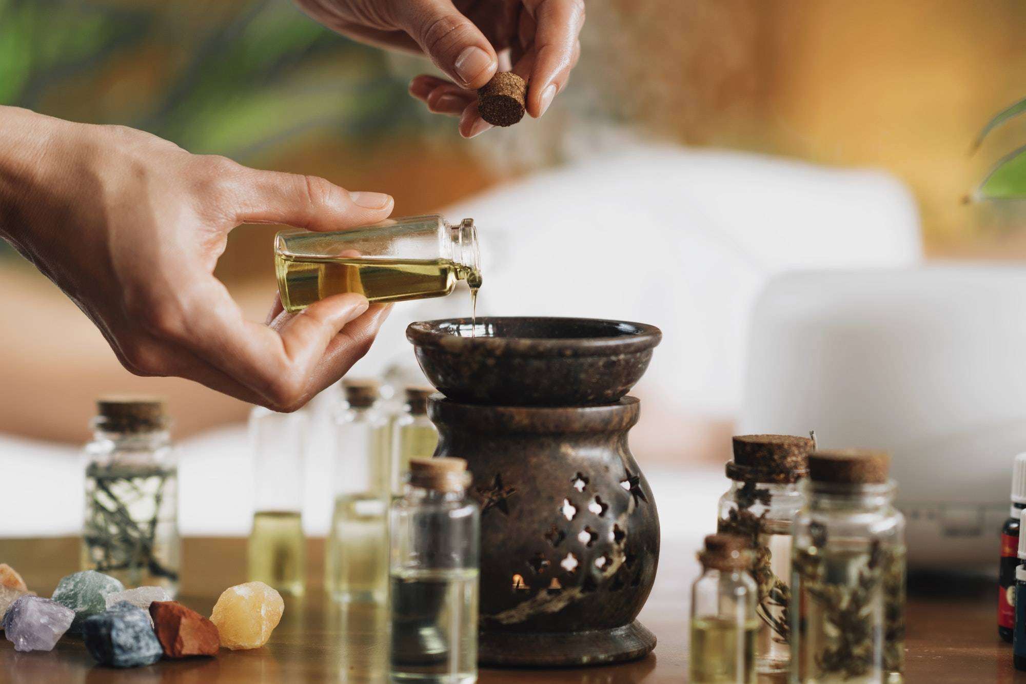 Ayurveda Aromatherapy Massage, Pouring Aromatic Oil in Essential Oil and incense burnerDiffuser