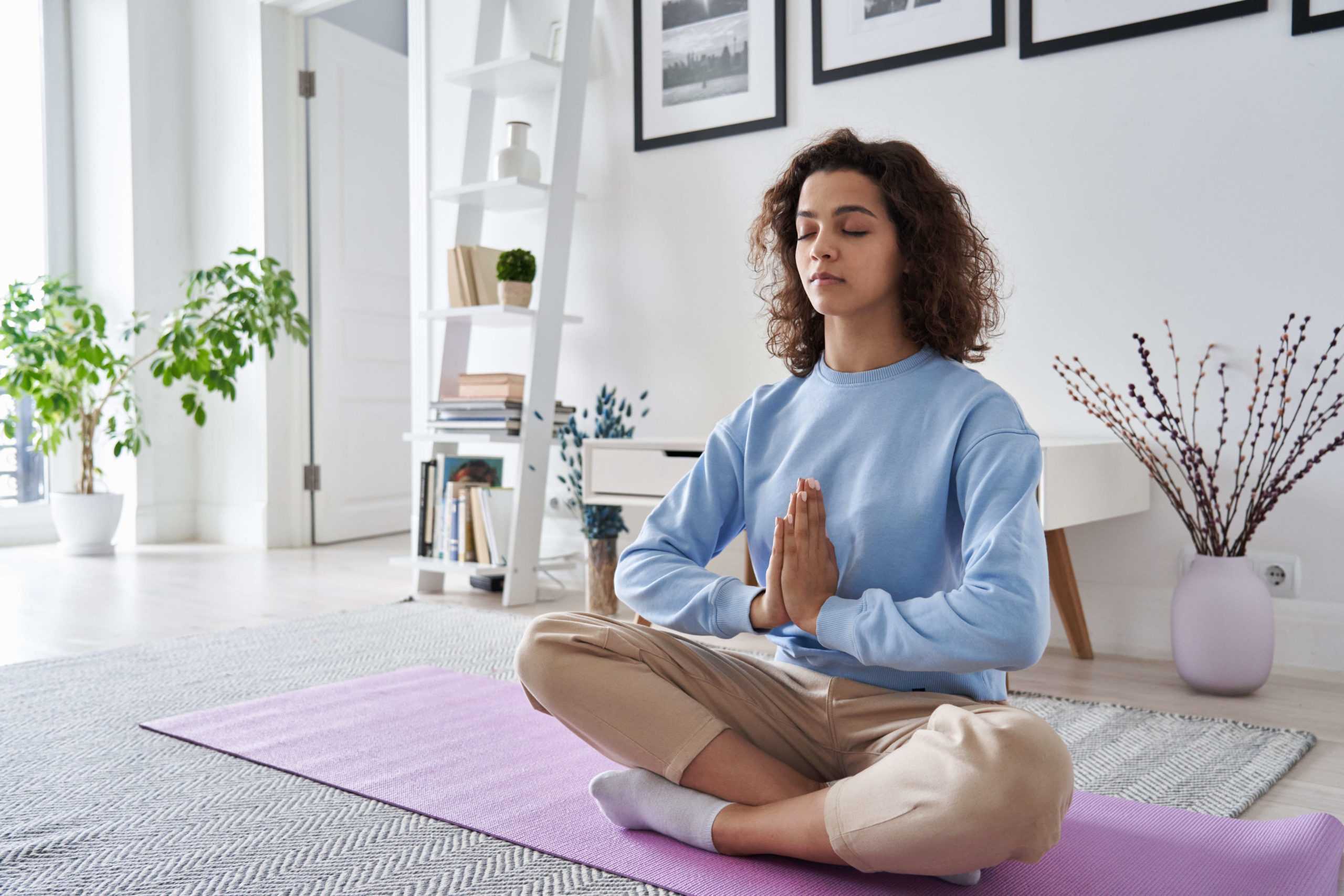 serene-healthy-young-woman-meditating-at-home-doin-2021-09-02-14-46-39-utc